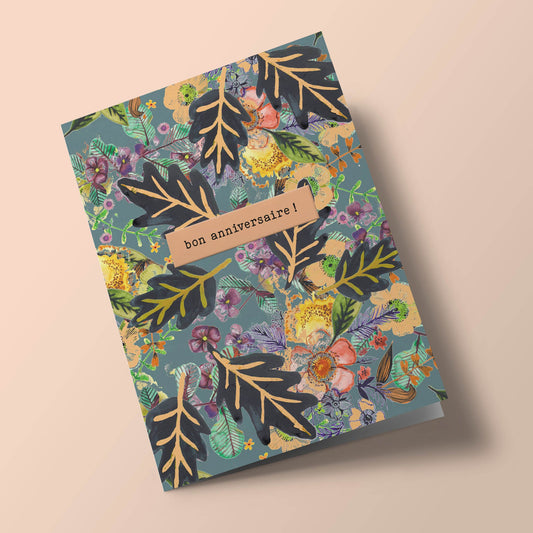 Say it with flowers - Bon anniversaire - black leaves and yellow flowers